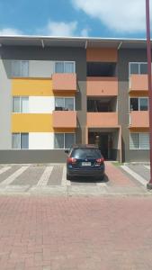 Un coche negro aparcado delante de un edificio en Ricks place, en Guayaquil