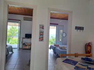a room with two beds and a room with two windows at BIZOS Beach in Koroni