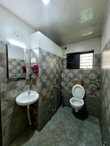 a bathroom with a toilet and a sink at Villa Del Sol - South Cliff, Varkala in Varkala +21 photos