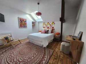 a bedroom with a white bed and a rug at Le domaine de Bachmay in Laval +252 photos