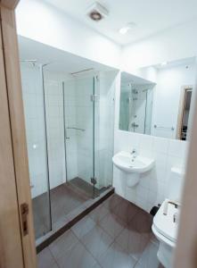 a bathroom with a shower and a sink at Modern Studio Suite at The Gallery in Accra