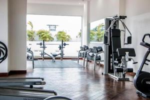 a gym with a bunch of treadmills and machines at Modern Studio Suite at The Gallery in Accra