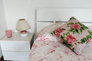 a bedroom with a bed with a pillow and a nightstand at Corte Vitelleria in Piazza