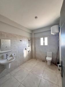 a bathroom with a sink and a toilet at The Home Siwa ذا هوم سيوة in Siwa +28 photos
