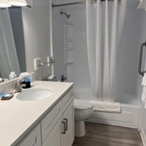 a bathroom with a sink and a toilet and a shower at Summer Sands - 303 by Sea Scape Properties in Wrightsville Beach