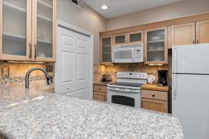 a kitchen with a white refrigerator and a counter top at Three Ridges 74 with Wintergreen Advantage in Wintergreen