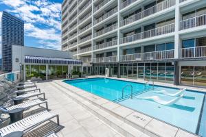 a large swimming pool in a building with chairs at Holiday Inn New Orleans-Downtown Superdome by IHG in New Orleans