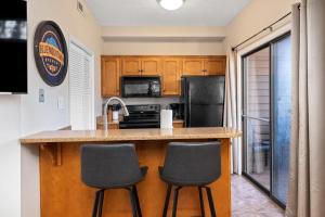 a kitchen with a counter and two stools at Laurelwood 84 with Wintergreen Advantage in Wintergreen