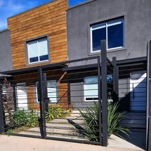 a house with a fence in front of it at Departamento Los Cardales in Los Cardales