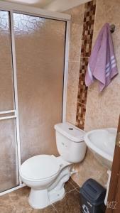 a bathroom with a toilet and a sink at HOSTAL S Y S in Cali +10 photos