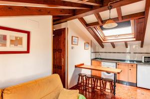 a kitchen with a table and chairs in a room at Apartamentos la Regoria in Arenas de Cabrales
