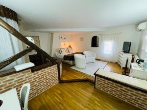 a living room with a couch and a room with a bed at Chambres d'Hôtes Au Clos Saint Georges in Saint-Jory