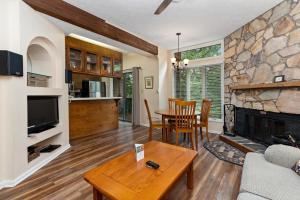 a living room with a table and a fireplace at Laurelwood 80 with Wintergreen Advantage in Wintergreen