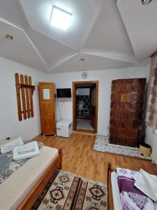 a room with two beds and a living room at CASA CU LAVANDĂ in Vatra Dornei