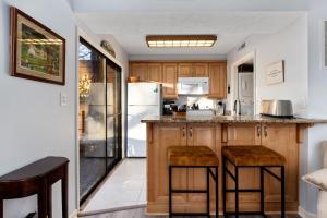 a kitchen with wooden cabinets and a white refrigerator at Laurelwood 43 with Wintergreen Advantage in Wintergreen