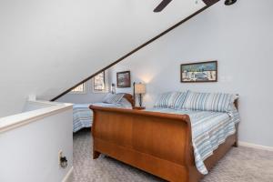 a attic bedroom with a bed and a staircase at Laurelwood 43 with Wintergreen Advantage in Wintergreen +13 photos