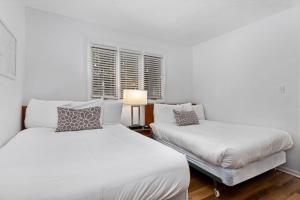 a white bedroom with two beds and a window at Laurelwood 25 with Wintergreen Advantage in Wintergreen +10 photos