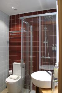 a bathroom with a shower and a toilet and a sink at Oporto Station Hostel & Rooms in Porto +21 photos