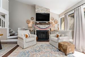 a living room with two chairs and a fireplace at White Oak 51 with Wintergreen Advantage in Wintergreen