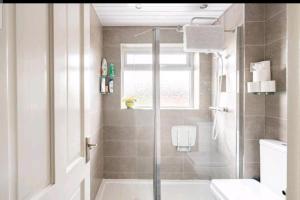 a bathroom with a shower and a toilet and a tub at 3 Bedroom - 1 Bathroom - Garden - Pet Friendly in Wrexham +28 photos