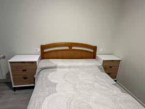 a bedroom with a bed with two dressers at Malteses in A Guarda