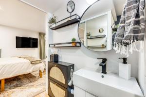a bathroom with a sink and a mirror at Lovers Lane Chalet Dtwn Manitou Springs Studio! in Manitou Springs