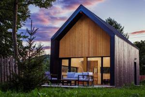 a small house with a blue roof at Cuibul Negru in Teşila