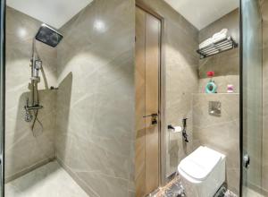 a bathroom with a shower stall and a toilet at HOTEL UPTOWN - Luxury Restaurant & Rooftop Near Connaught Place in New Delhi