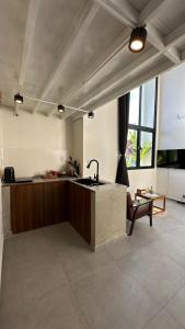 a kitchen with a sink in the middle of a room at Kors Loft Apartment in Phnom Penh