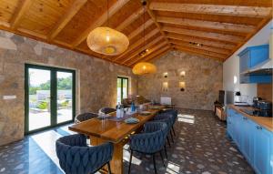 a kitchen and dining room with a wooden table and chairs at 4 Bedroom Cozy Home In Krusevo in Kruševo