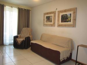 a bedroom with a bed and a chair at Residence 207 Cabo Branco in João Pessoa +43 photos