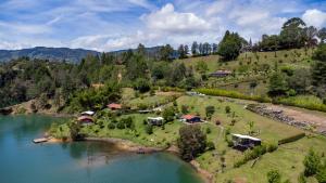 an aerial view of a house on a hill next to a lake at Marina Navegar in Guatapé