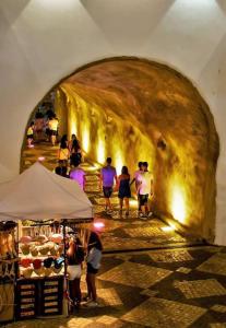 a group of people walking through a tunnel at Apartamento T1 centro Albufeira in Albufeira