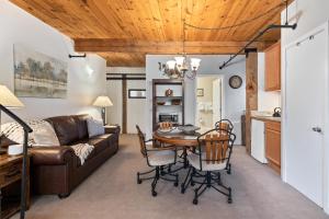 a living room with a table and a couch at Mountain Inn Studio 53 with Wintergreen Advantage in Wintergreen