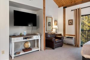 a living room with a television and a chair at Mountain Inn Studio 53 with Wintergreen Advantage in Wintergreen