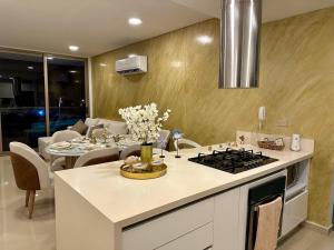 una cocina con una mesa y una estufa horno superior en 403 - Samaria Club de Playa, en Gaira