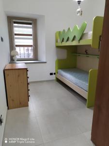 a room with a bed and a desk and a window at La Rocchetta - Ai piedi del Parco Naturale in Cavour +5 photos