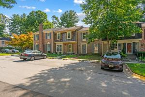 a car parked in a parking lot in front of a house at zarah Vacation Home cozy home near Washington DC in Montgomery Village