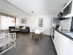a kitchen and living room with a couch and a table at Las Dunas Blancas - Roof Top - by FTV Holidays Homes in Villaverde