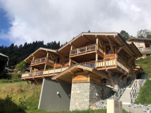 a large wooden house on top of a hill at Appartement cosy en duplex, 8 pers, parking, Les Gets - FR-1-598-59 in Les Gets
