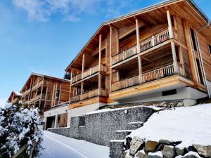 a large wooden building with snow in front of it at T3 aux Gets, vue sur pistes - FR-1-598-5 in Les Gets