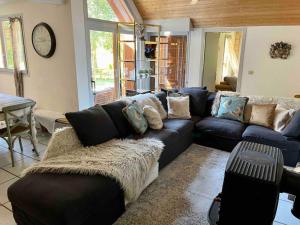 a living room with a blue couch and a table at Maison Étoile - Explore Oisans, Fabulous house for 10 guests, Allemond in Allemont