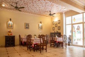a dining room with a table and chairs at Anuraag Villa in Jaipur