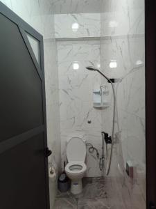 a white bathroom with a toilet and a shower at Sea Breeze in Imsouane +11 photos