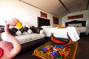 a living room with a couch and a bed at Uros mojsa lodge in Puno