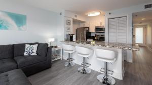 a living room with a couch and a kitchen at Blue Haven Key LargoOcean Pointe 1315 in Key Largo