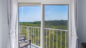 a room with a window with a view of the woods at Blue Haven Key LargoOcean Pointe 1315 in Key Largo