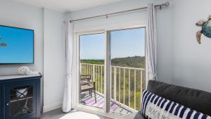 a living room with a fireplace and a sliding glass door at Blue Haven Key LargoOcean Pointe 1315 in Key Largo +66 photos