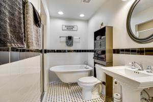 a bathroom with a toilet and a sink and a tub at Hot Tub and Fire Pit Possum Kingdom Lake Retreat! in Strawn +25 photos