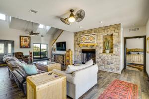 a living room with a couch and a fireplace at Hot Tub and Fire Pit Possum Kingdom Lake Retreat! in Strawn
